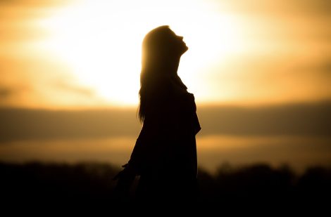 Youth woman soul at orange sun meditation awaiting future times.